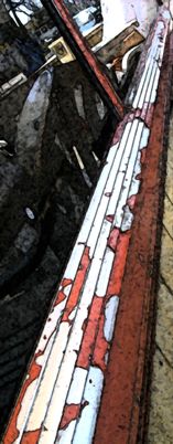 Red Paint Peels on a Rail